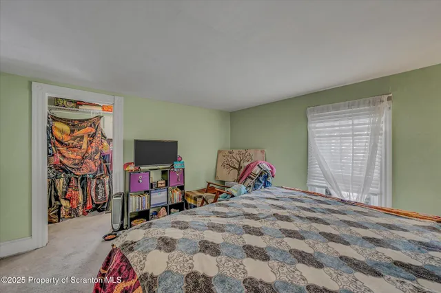 a bed room with a bed and a tv