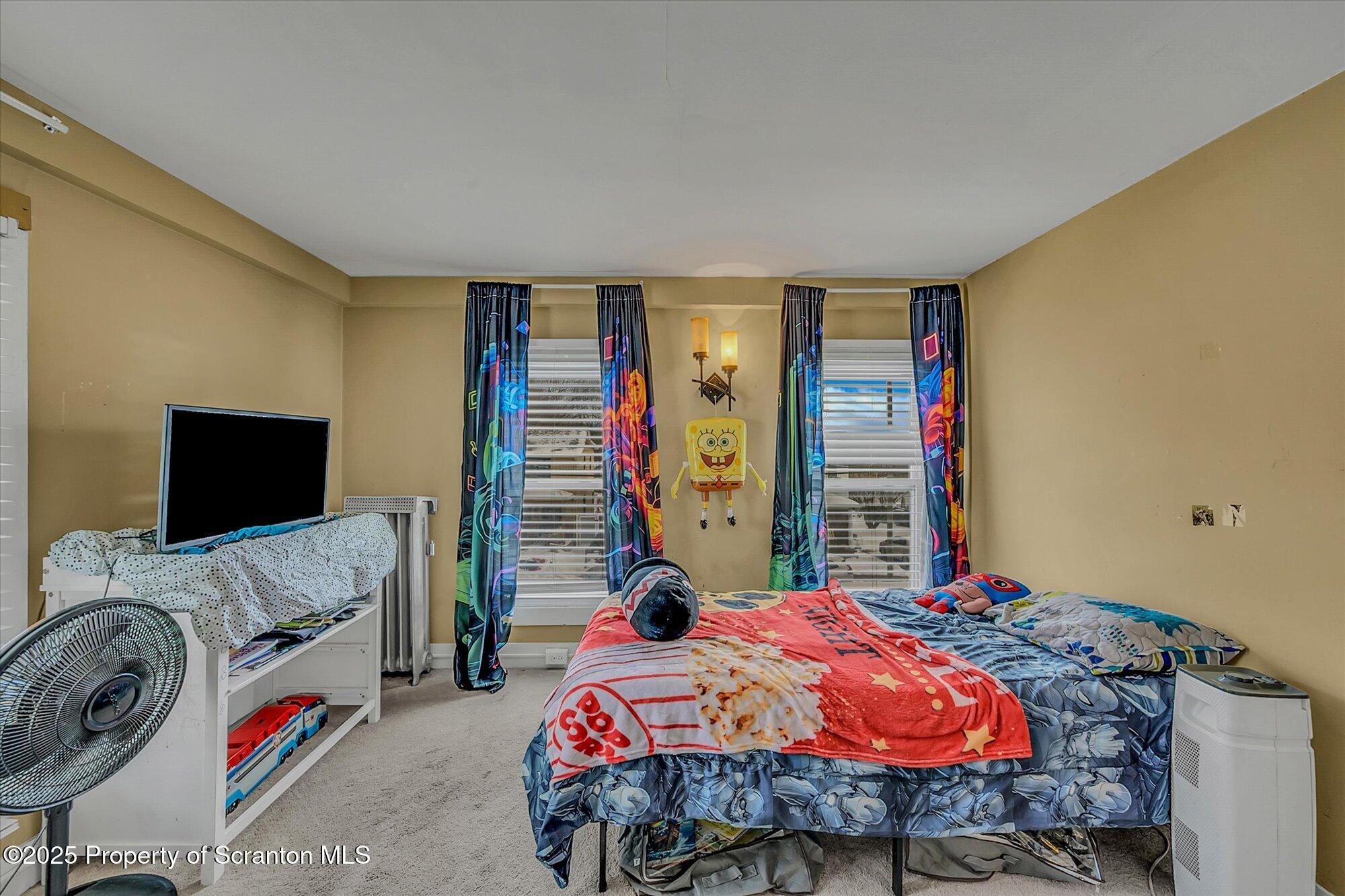 219 1st Street Olyphant, PA 18447 - Photo 36 of 43 a bedroom with bed and a flat screen tv