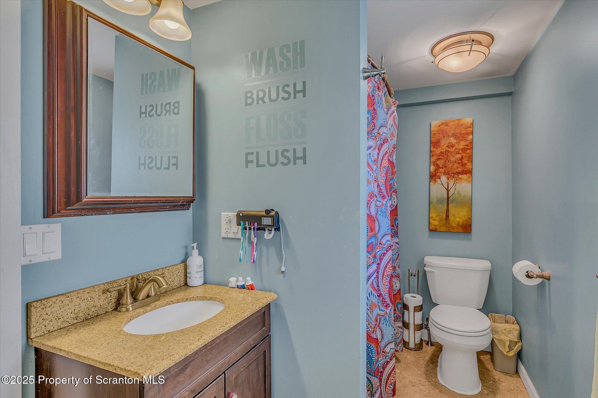 219 1st Street Olyphant, PA 18447 - Photo 40 of 43 a bathroom with a sink a toilet and a mirror