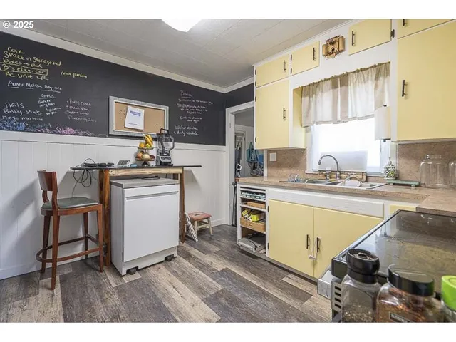 a kitchen with a sink cabinets and window