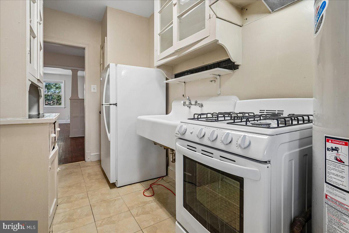 3944 7th Street Northeast, Unit 4 Washington, DC 20017 - Photo 11 of 19 a kitchen with stainless steel appliances granite countertop a stove a refrigerator and a cabinets
