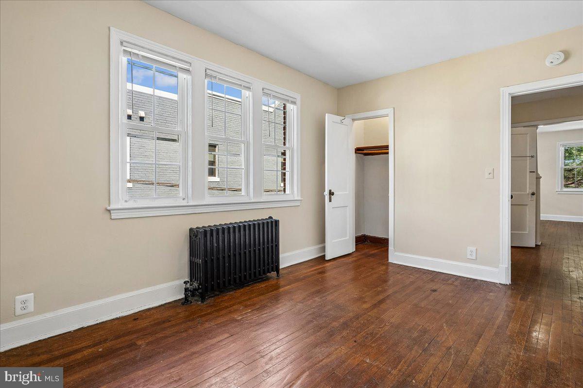 3944 7th Street Northeast, Unit 4 Washington, DC 20017 - Photo 13 of 19 wooden floor in an empty room with a window