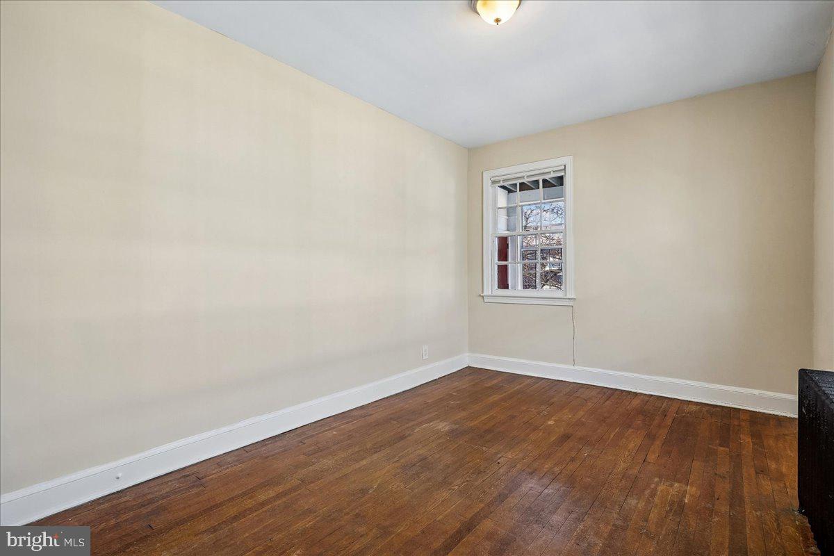 3944 7th Street Northeast, Unit 4 Washington, DC 20017 - Photo 15 of 19 an empty room with wooden floor and windows