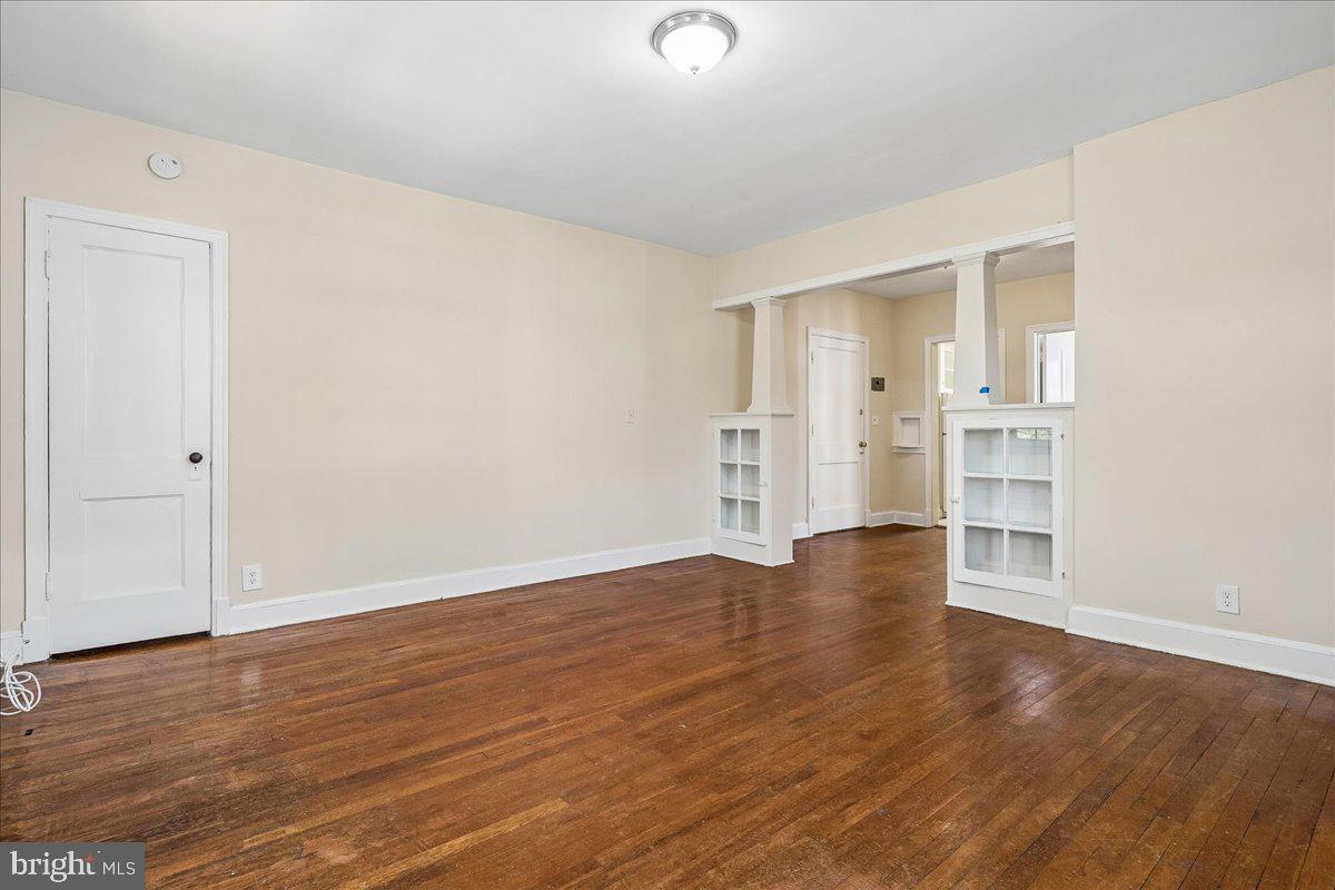 3944 7th Street Northeast, Unit 4 Washington, DC 20017 - Photo 5 of 19 an empty room with wooden floor & windows and bathroom