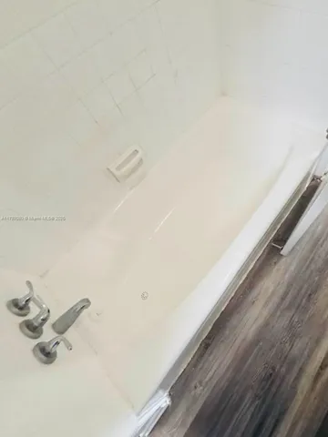 a kitchen with a refrigerator stove and wooden cabinets