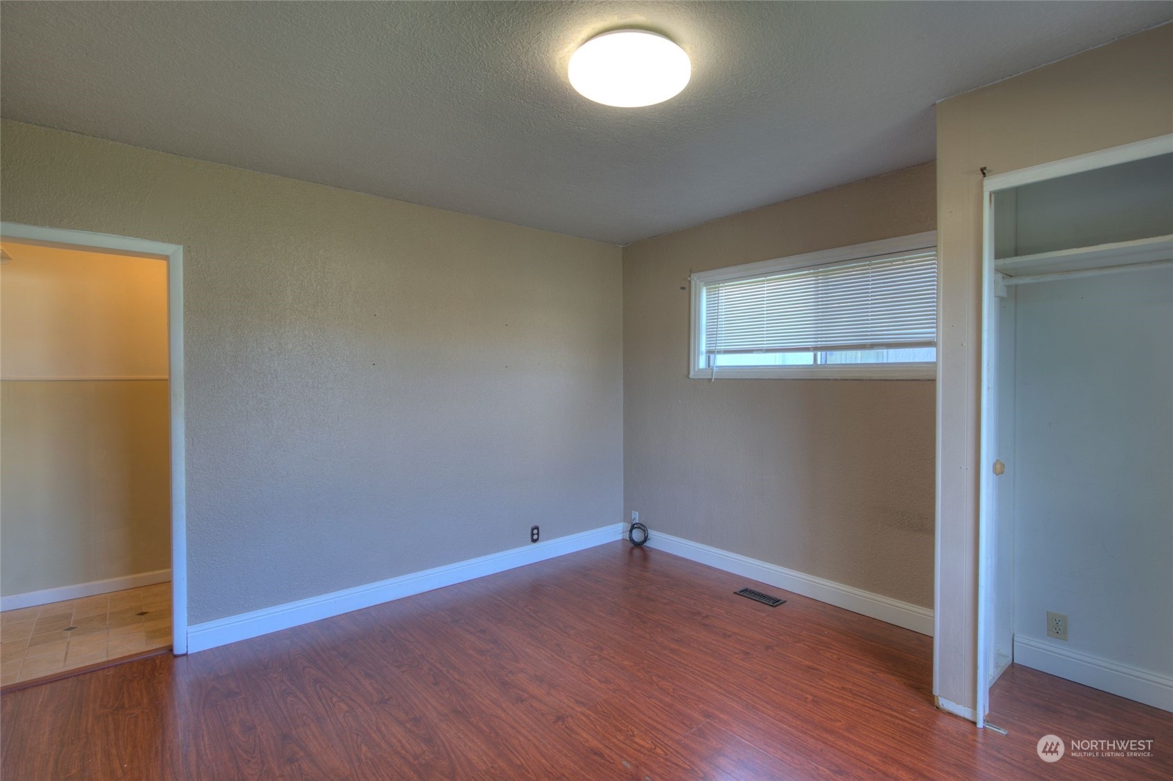 2205 West Second Street Aberdeen, WA 98520 - Photo 16 of 22 an empty room with wooden floor and windows