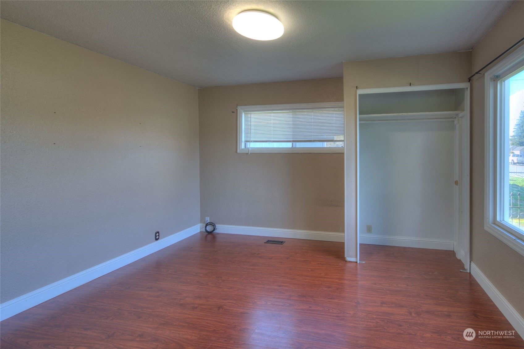 2205 West Second Street Aberdeen, WA 98520 - Photo 18 of 22 an empty room with wooden floor and windows