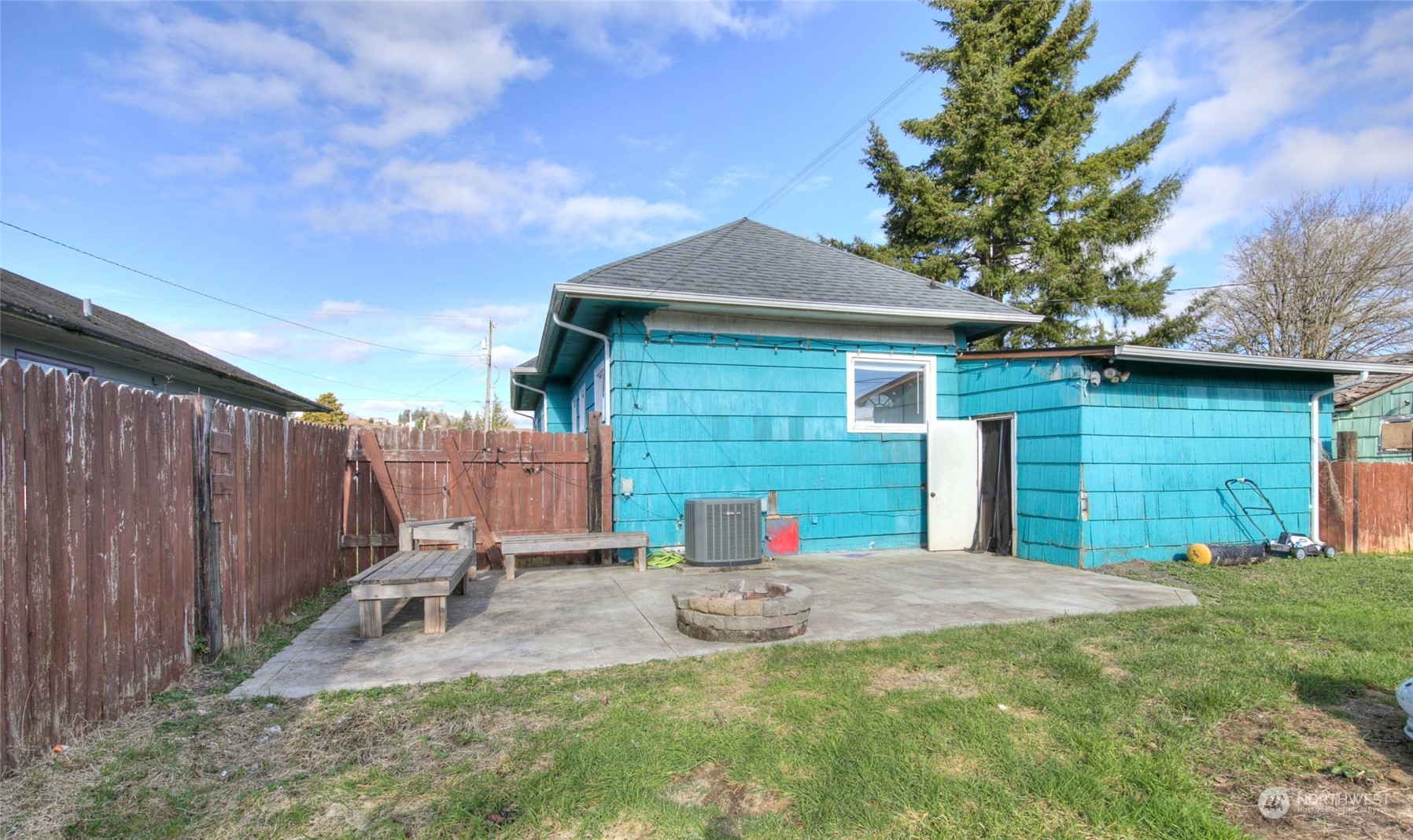 2205 West Second Street Aberdeen, WA 98520 - Photo 22 of 22 a view of a backyard with a small cabin and a chair