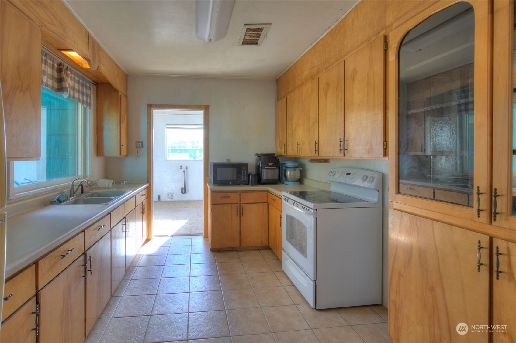 2205 West Second Street Aberdeen, WA 98520 - Photo 8 of 22 a kitchen with a stove sink and cabinets