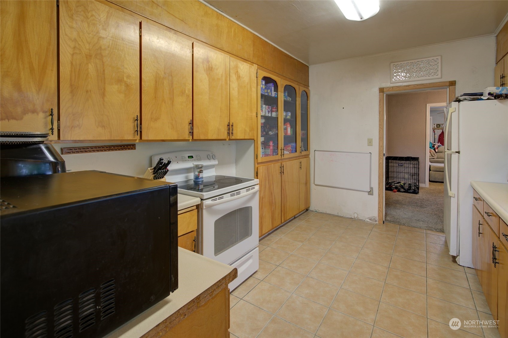 2205 West Second Street Aberdeen, WA 98520 - Photo 9 of 22 a kitchen with stainless steel appliances a refrigerator a sink a stove and white cabinets