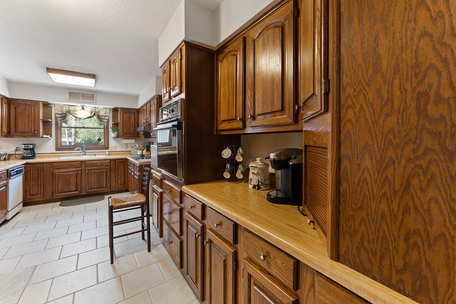 3687 Airport Road Crestview, FL 32539 - Photo 11 of 74 a kitchen with stainless steel appliances granite countertop a sink and cabinets