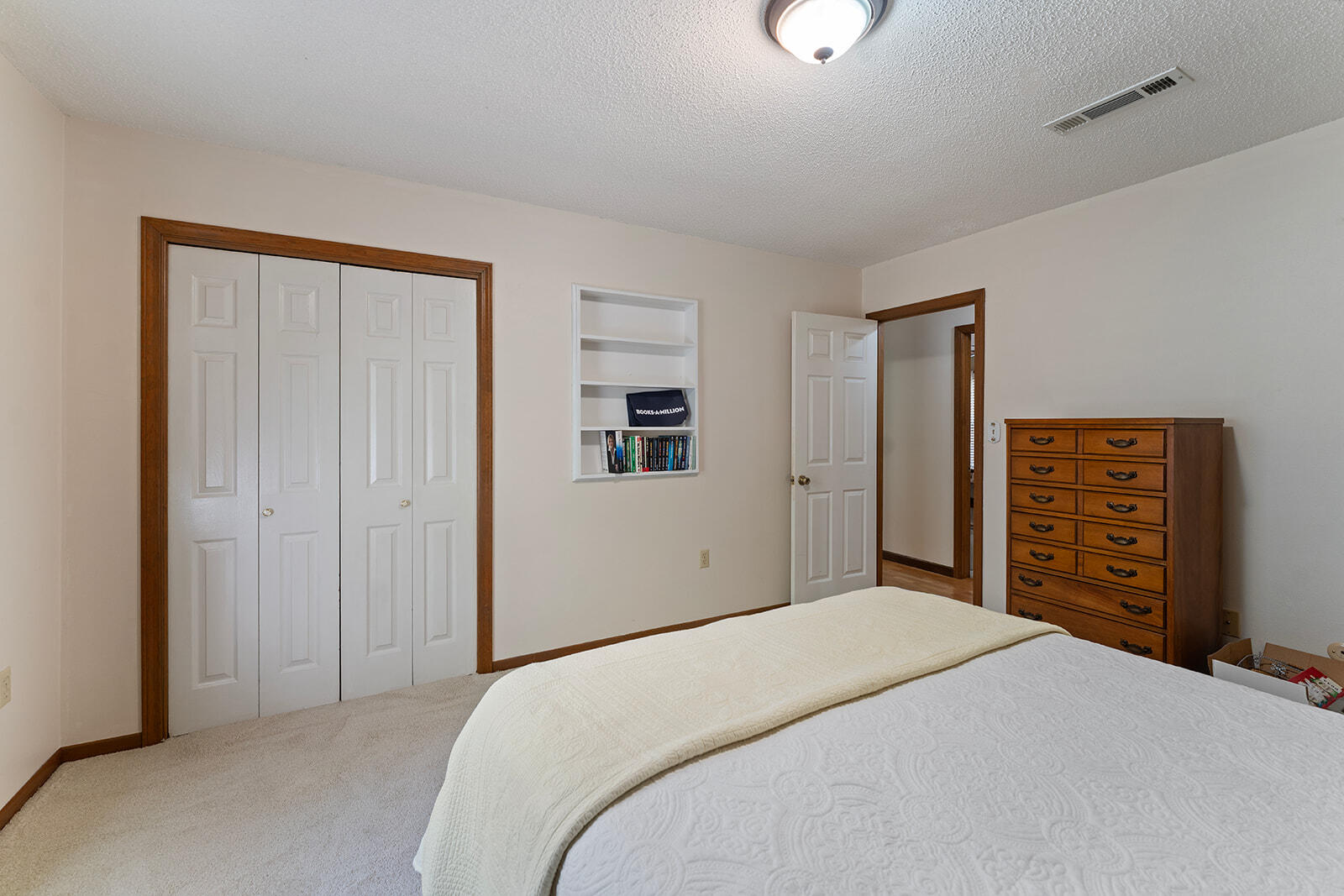 3687 Airport Road Crestview, FL 32539 - Photo 29 of 74 a bedroom with a bed and a chandelier