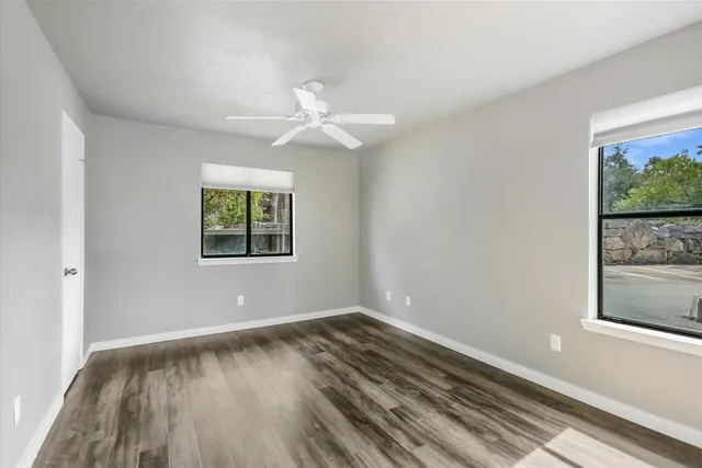 wooden floor in an empty room with a window