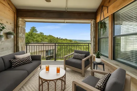 a balcony with furniture and a potted plant