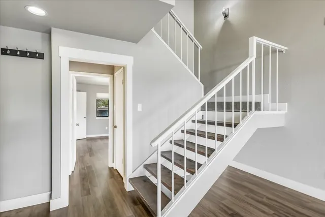 a view of entryway and hall with wooden floor