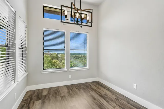 a view of a room with wooden floor and windows