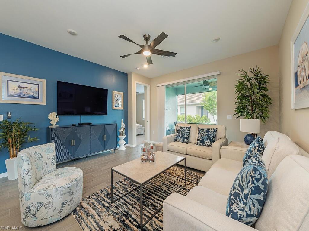 1209 Enbrook Loop Naples, FL 34114 - Photo 2 of 15 Living room featuring ceiling fan and hardwood / wood-style floors