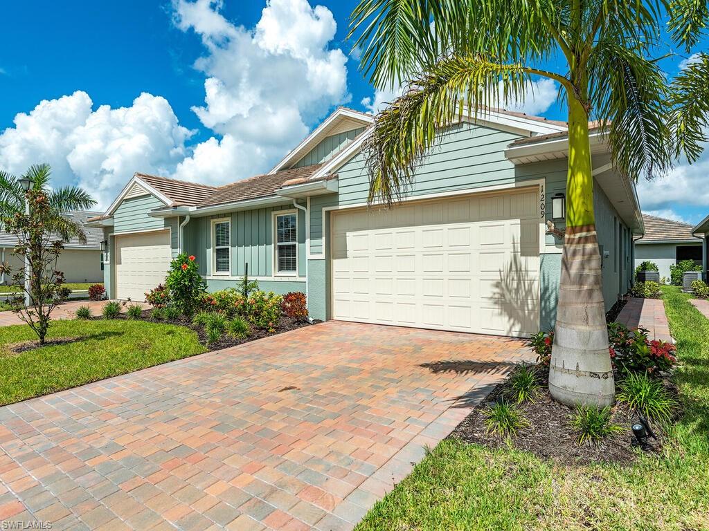 1209 Enbrook Loop Naples, FL 34114 - Photo 3 of 15 View of front of home featuring a garage