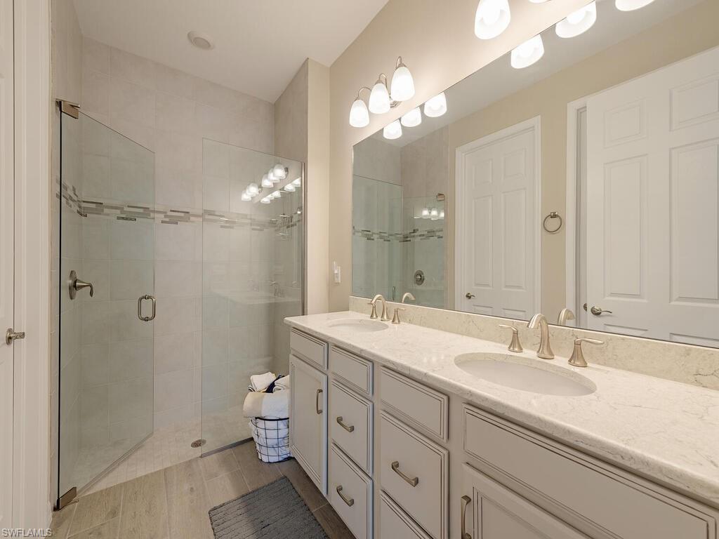 1209 Enbrook Loop Naples, FL 34114 - Photo 7 of 15 Bathroom with dual vanity and walk in shower