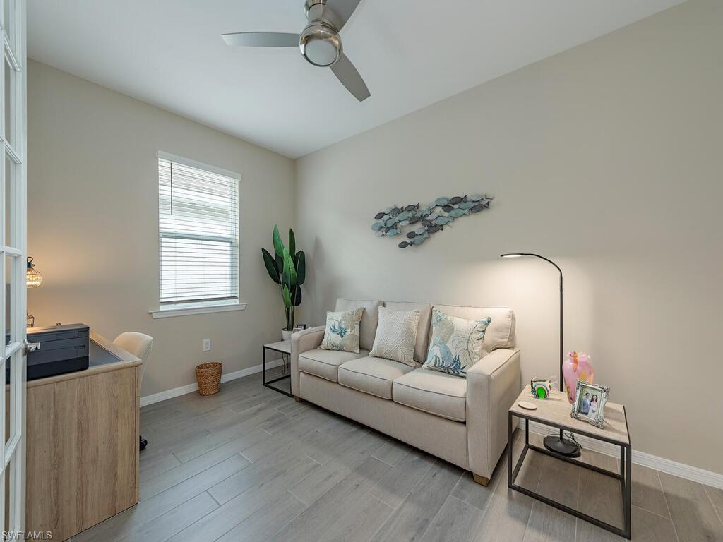 1209 Enbrook Loop Naples, FL 34114 - Photo 10 of 15 Living room featuring light hardwood / wood-style floors and ceiling fan