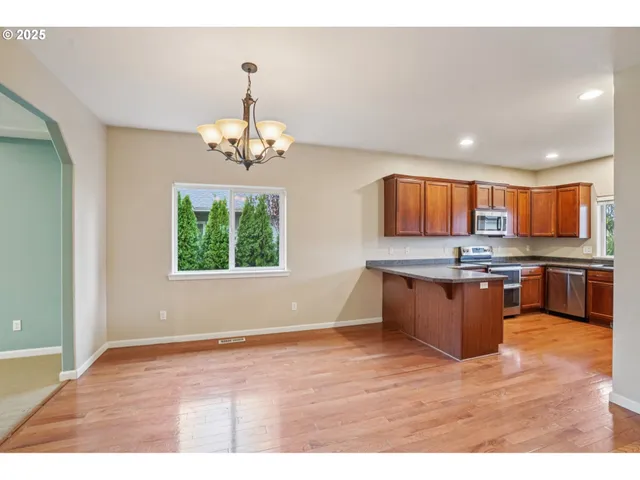 a large kitchen with kitchen island granite countertop a large counter top and stainless steel appliances