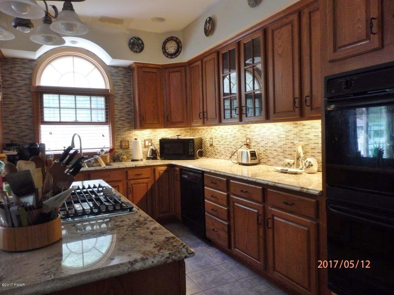 271 Sawmill Road Greentown, PA 18426 - Photo 6 of 36 a kitchen with stainless steel appliances granite countertop a stove a sink and a microwave