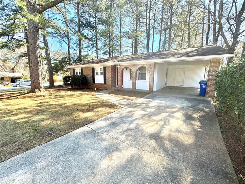 a view of a house with a yard and trees