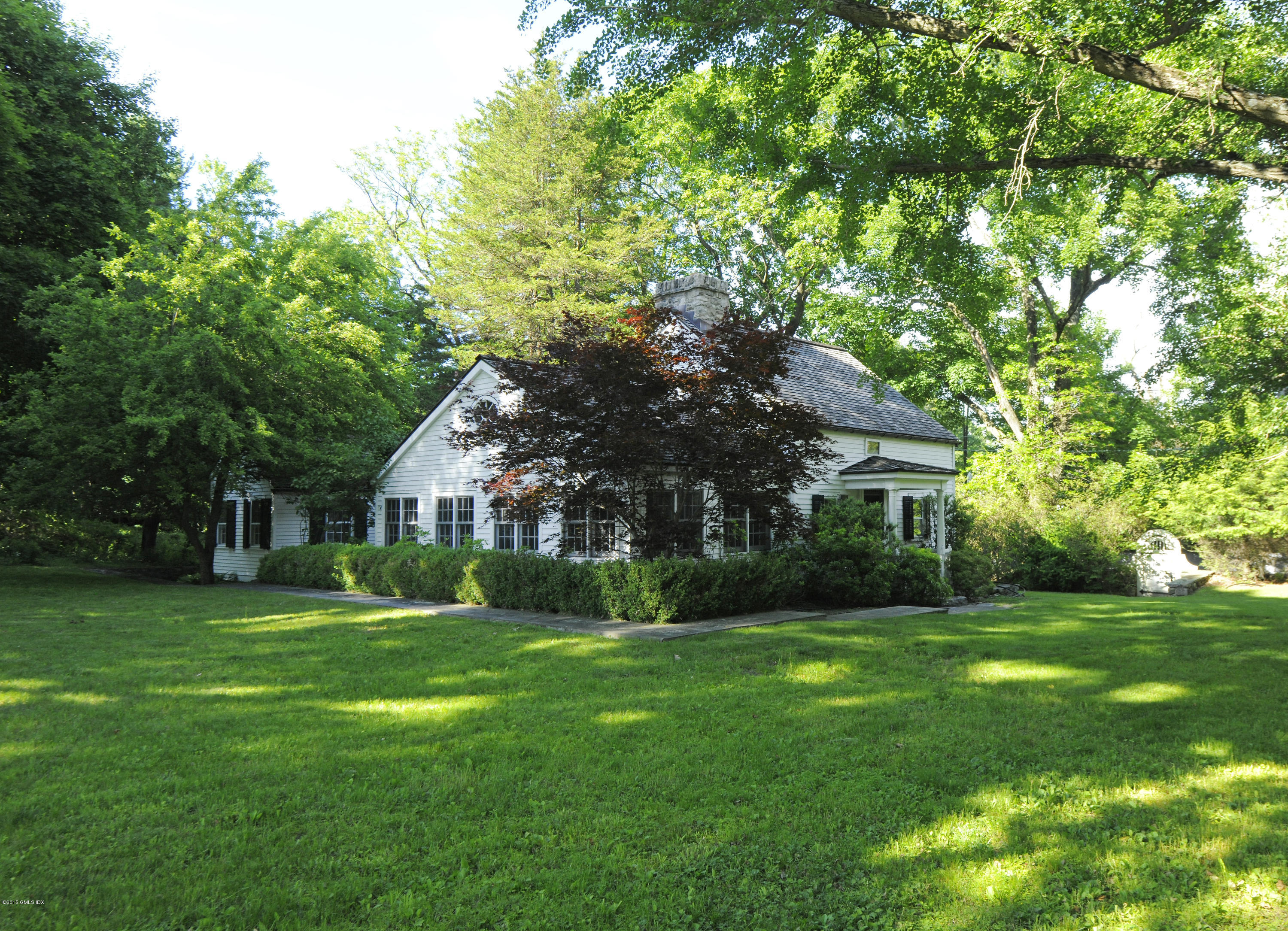 23 Cliffdale Road Greenwich, CT 06831 - Photo 17 of 24 a front view of house with yard and green space