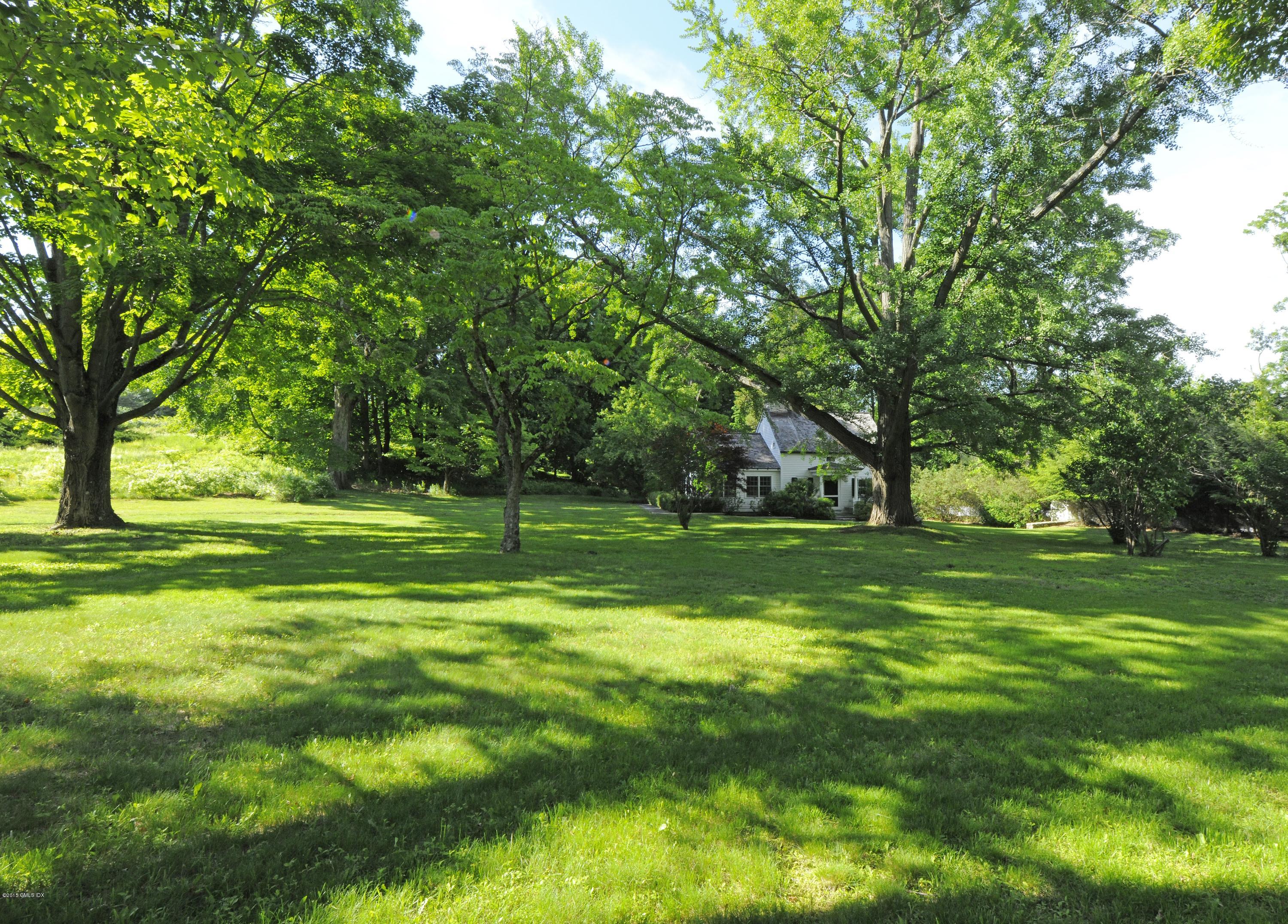 23 Cliffdale Road Greenwich, CT 06831 - Photo 3 of 24 a view of a grassy field with trees