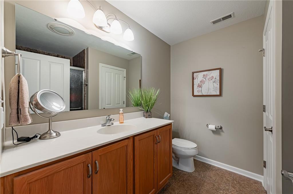 424 Chestnut Lane Apollo, PA 15613 - Photo 21 of 33 a bathroom with a granite countertop sink toilet and a mirror