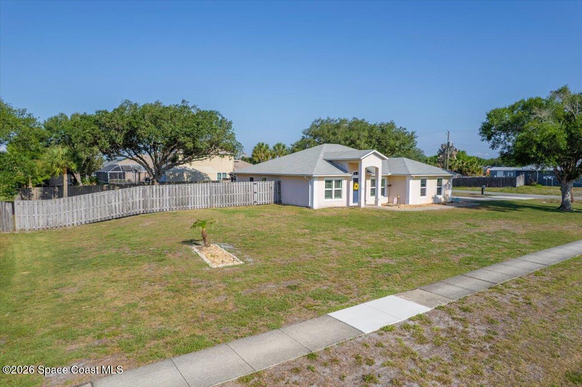 5975 Aruin Street Cocoa, FL 32927 - Photo 39 of 70 a swimming pool with wooden fence