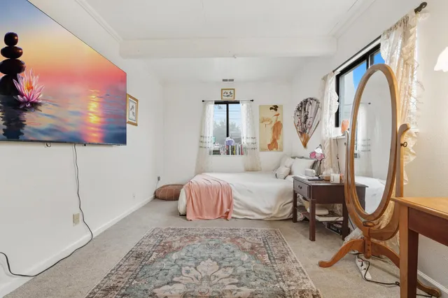 a bedroom with a bed a desk and chair