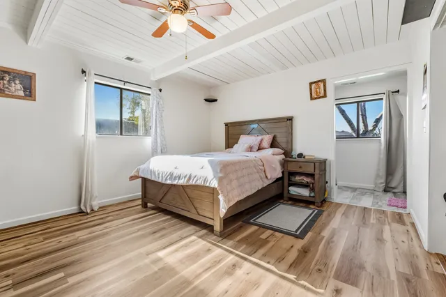 a bedroom with a bed lamp and a window