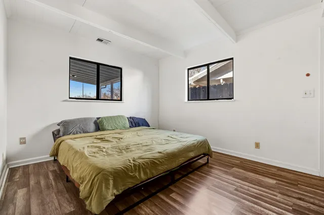 a bedroom with a bed and a wall painting