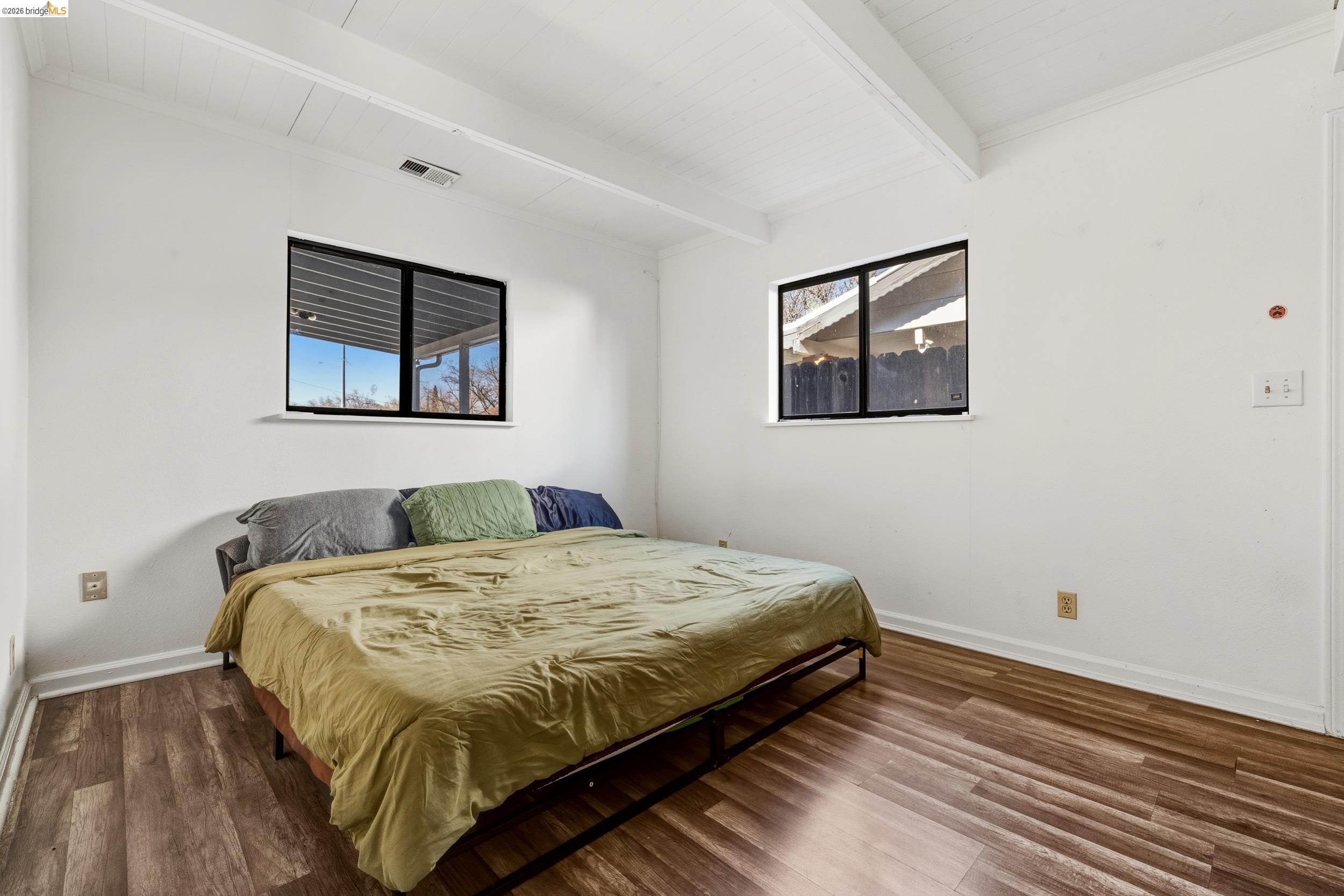 1704 East Street Tracy, CA 95376 - Photo 18 of 29 Bedroom with wood finished floors, multiple windows, and a wood ceiling with exposed beams