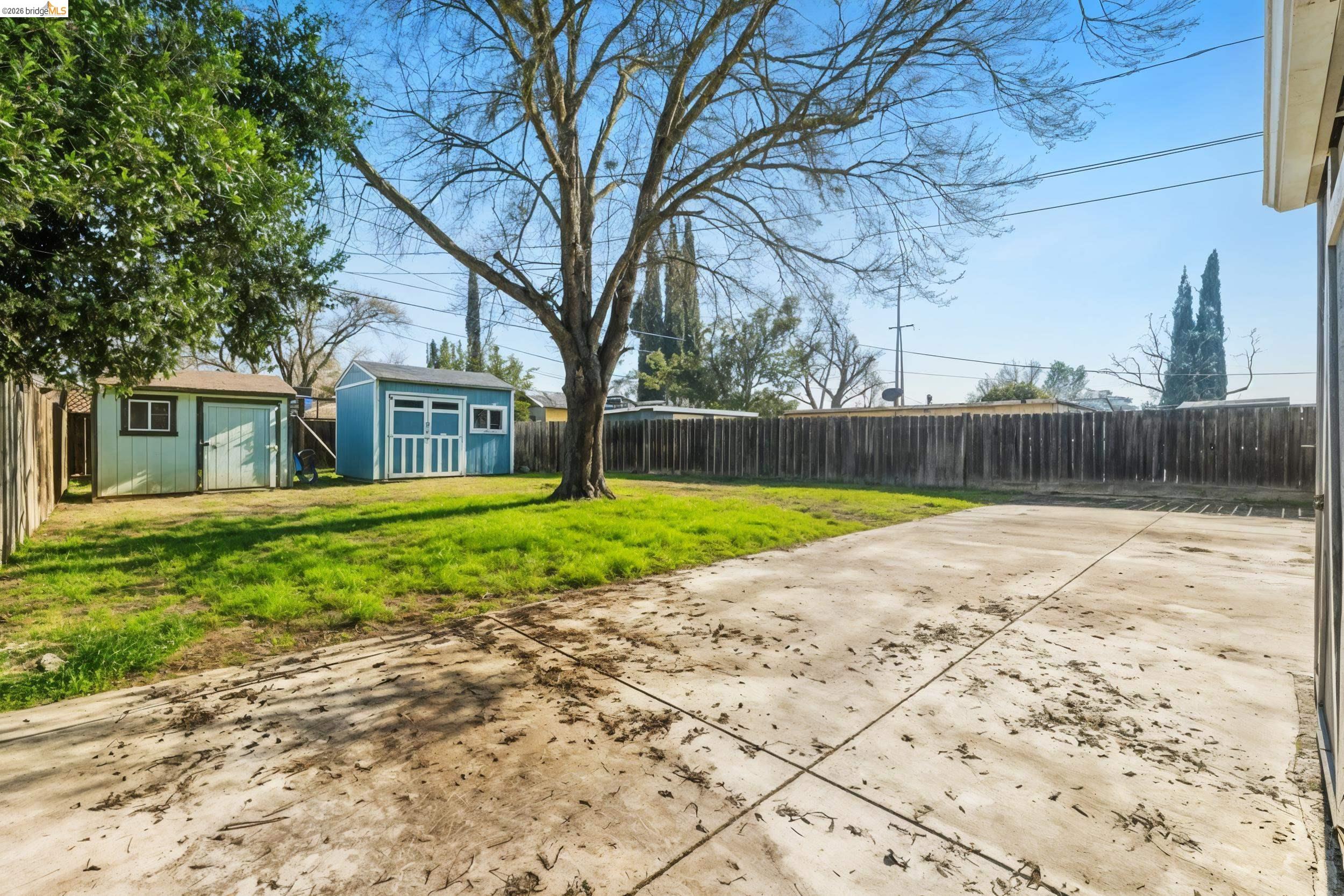 1704 East Street Tracy, CA 95376 - Photo 20 of 29 Fenced backyard with a shed and a patio