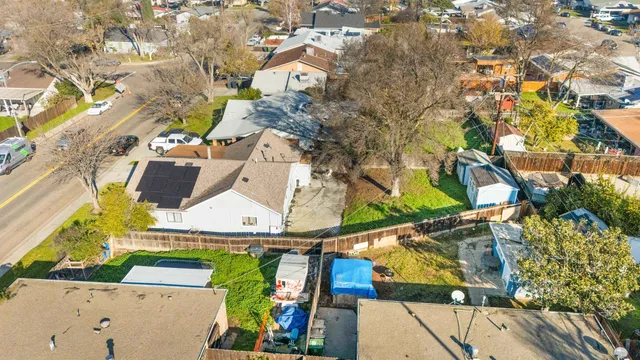 an aerial view of a houses with street