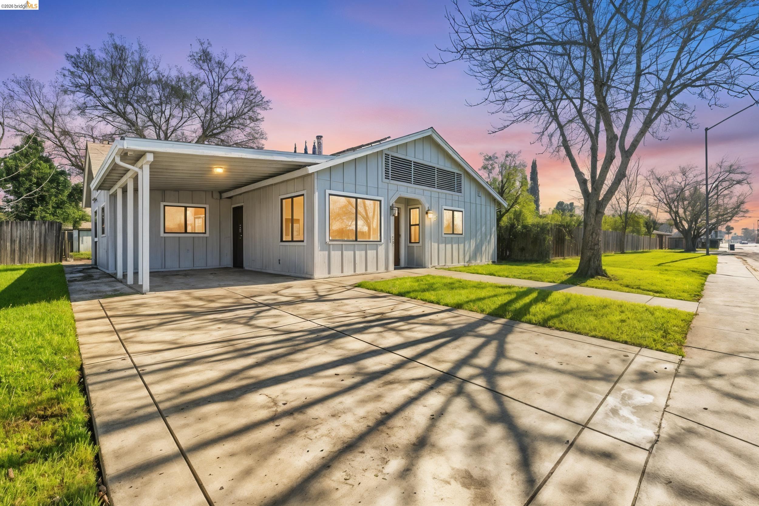 1704 East Street Tracy, CA 95376 - Photo 4 of 29 View of front of house with an attached carport, concrete driveway, and board and batten siding