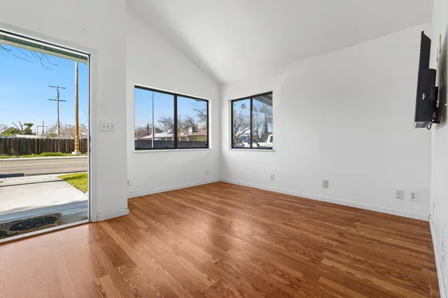 a view of a room with window and wooden floor