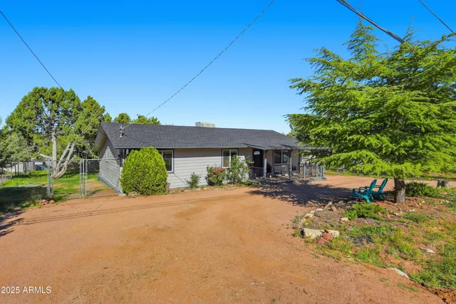 a view of a house with a yard and potted plants