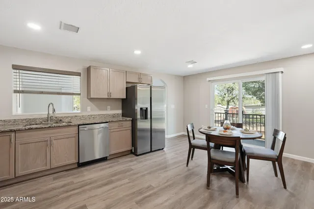 a kitchen with granite countertop a sink cabinets and window