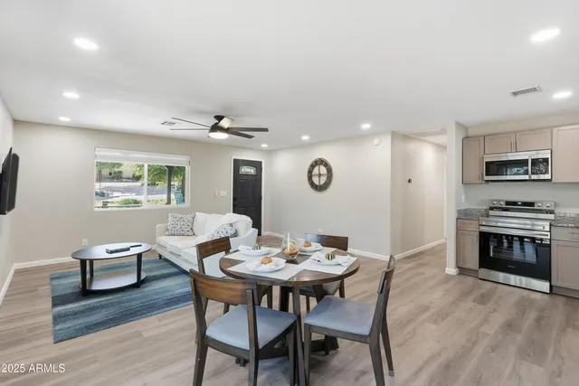 a view of a dining room with furniture window and wooden floor