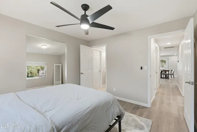 a bedroom with a large bed and a chandelier