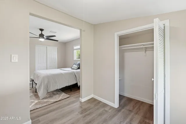 a bedroom with a bed and a ceiling fan