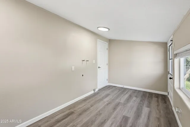 a view of room with window and wooden floor