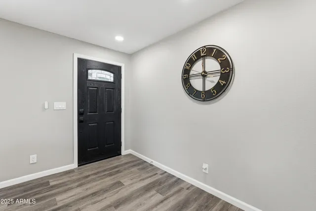 an empty room with mirror and window