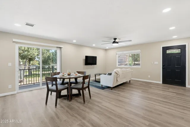 a view of a livingroom with furniture window and wooden floor