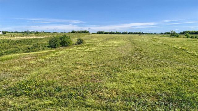 a view of a field with an ocean