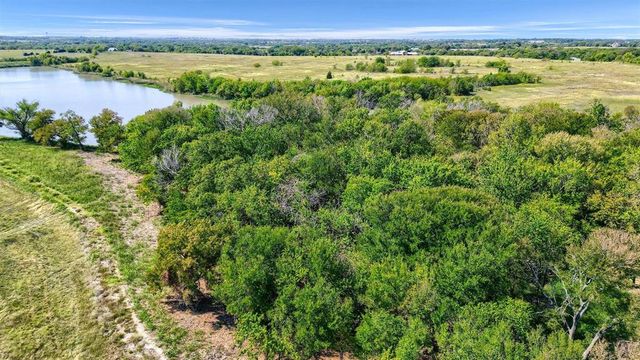 a view of a field with an ocean