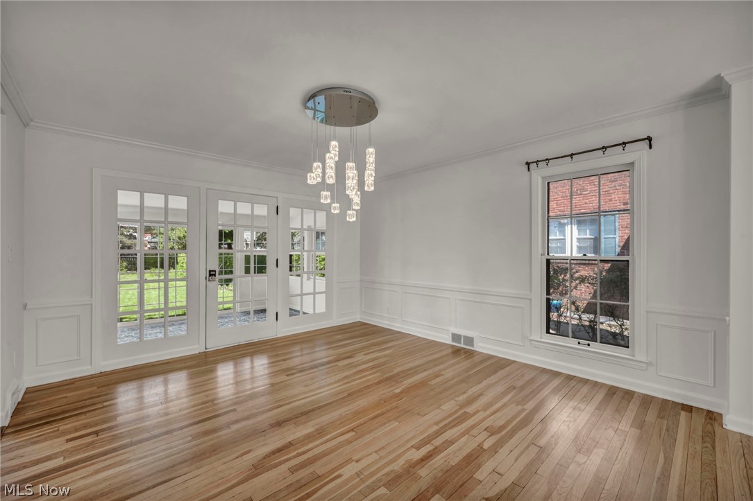 3543 Lytle Road Shaker Heights, OH 44122 - Photo 13 of 49 Hardwood flooring throughout featuring white wainscoting and crown molding